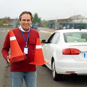 Driving Instructor is holding cones for driving test in Irving TX