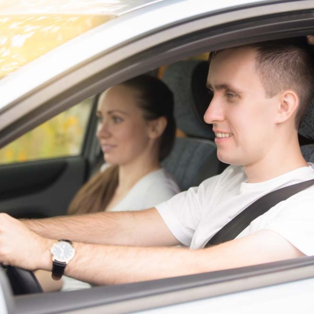 A young man gearing up for his driving test accompanied by his driving instructor at our driving school.