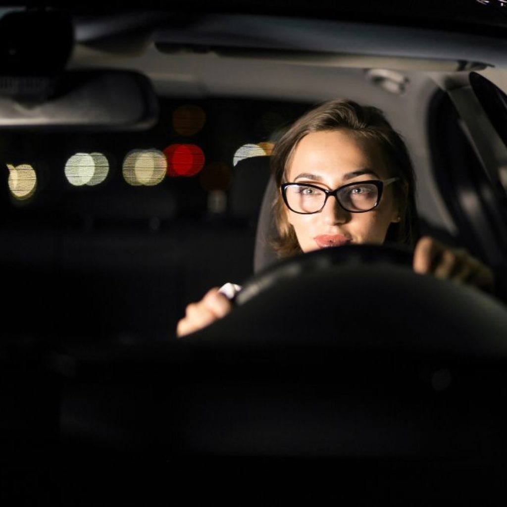 A young woman, wearing glasses is practicing various driving maneuvers on the road, which were instructed during their Drivers Ed in Grapevine.
